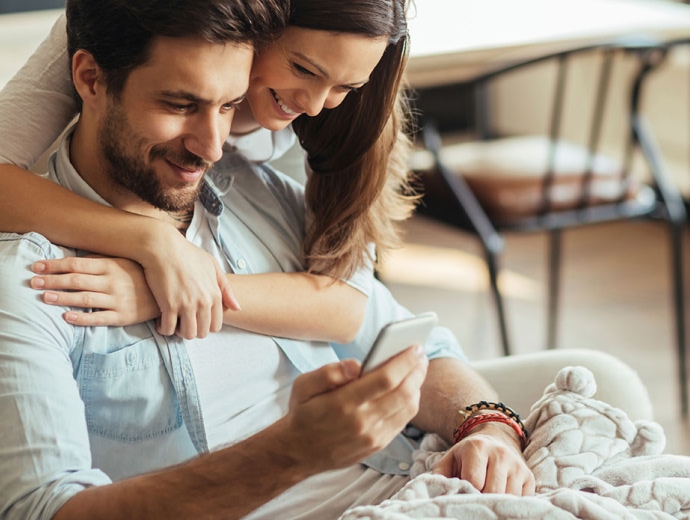 young couple looking at a smartphone